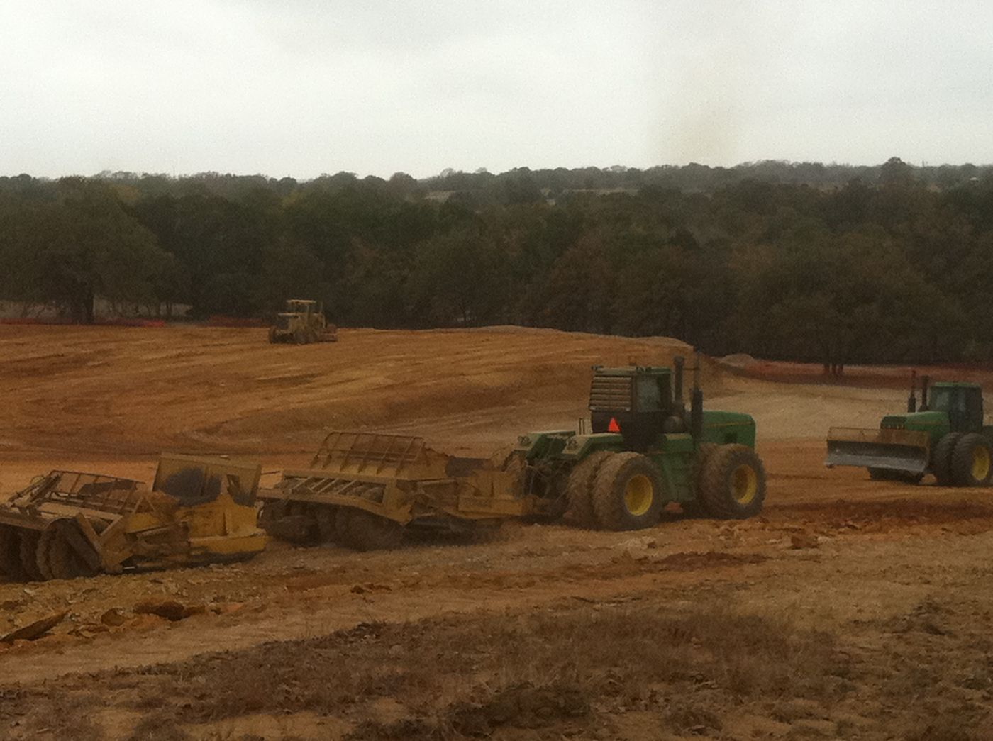 Scrapers and tractors on a large earthwork site